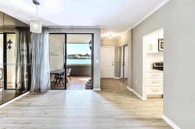 a view of a livingroom with wooden floor and furniture