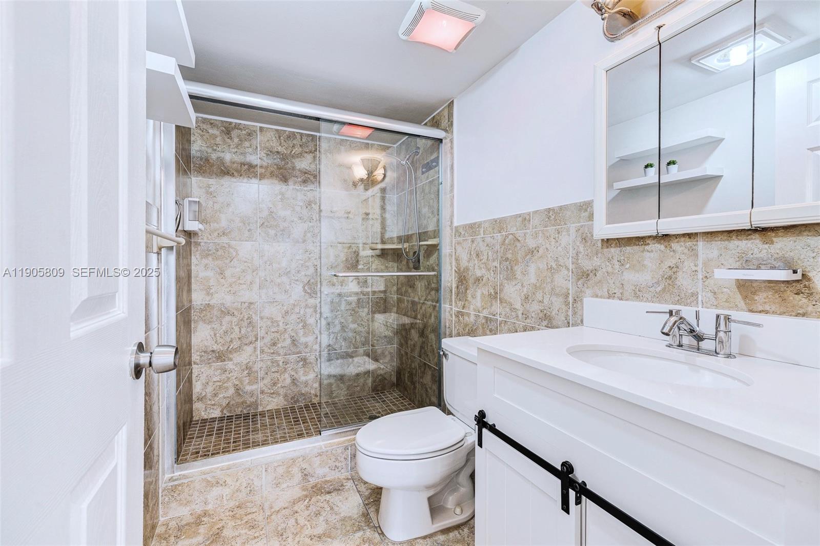 770 Northeast 199th Street, Unit 106F Miami, FL 33179 - Photo 9 of 25 a bathroom with a sink toilet and shower