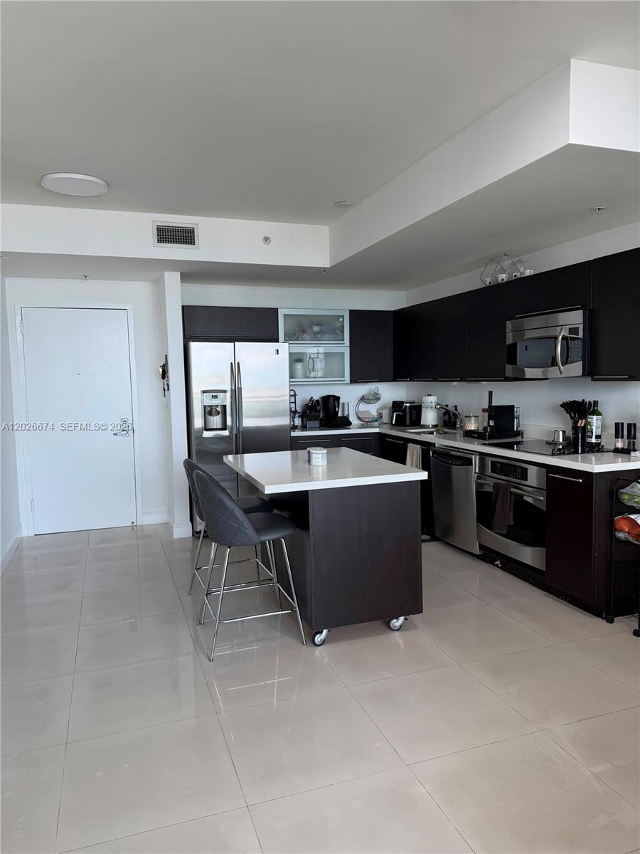 90 Southwest 3rd Street, Unit 4006 Miami, FL 33130 - Photo 5 of 19 a kitchen with a sink a counter top space and appliances