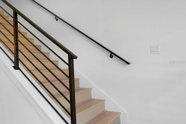 a large bed sitting in a bedroom next to a window