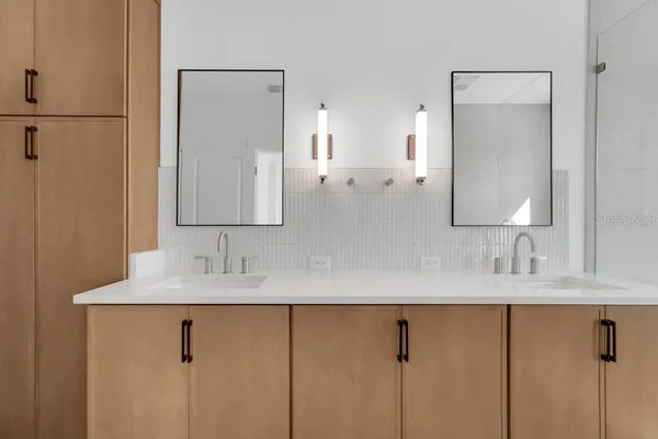a bathroom with a double vanity sink and a mirror