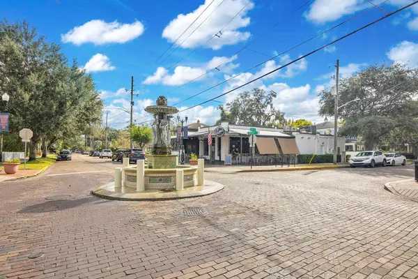 a view of a street with cars parked
