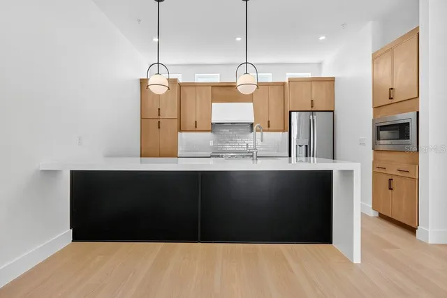 a kitchen with appliances and cabinets