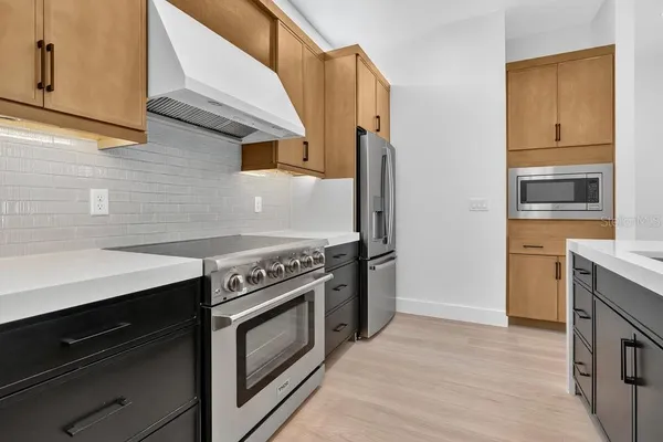 a kitchen with a stove and a microwave
