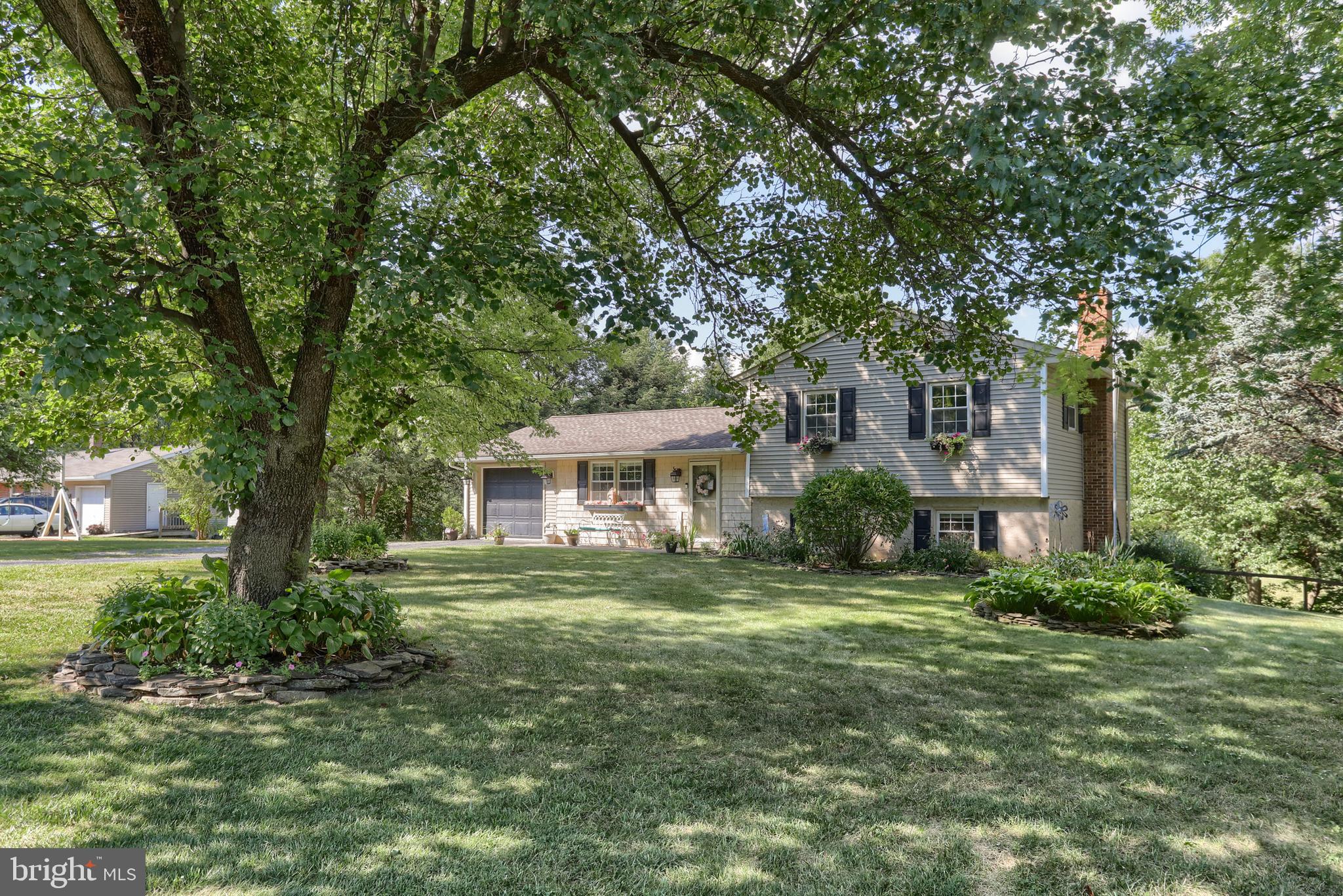1586 Loop Road Manheim, PA 17545 - Photo 3 of 42 a front view of a house with a garden