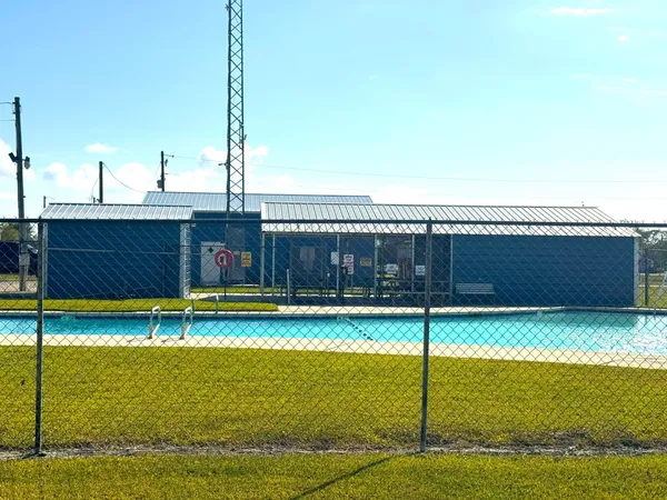 a view of a swimming pool with a yard