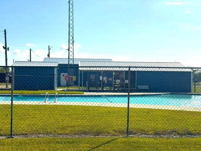 a view of a swimming pool with a yard