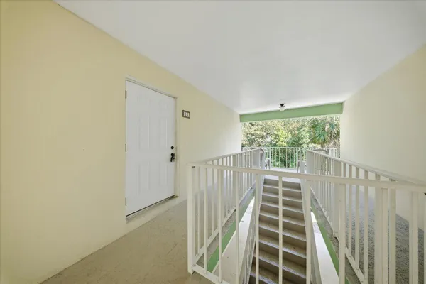 a view of a hallway with wooden floor and fence