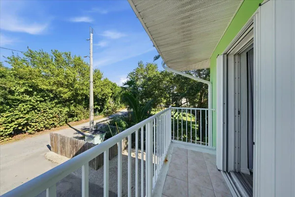 a view of a balcony with wooden floor