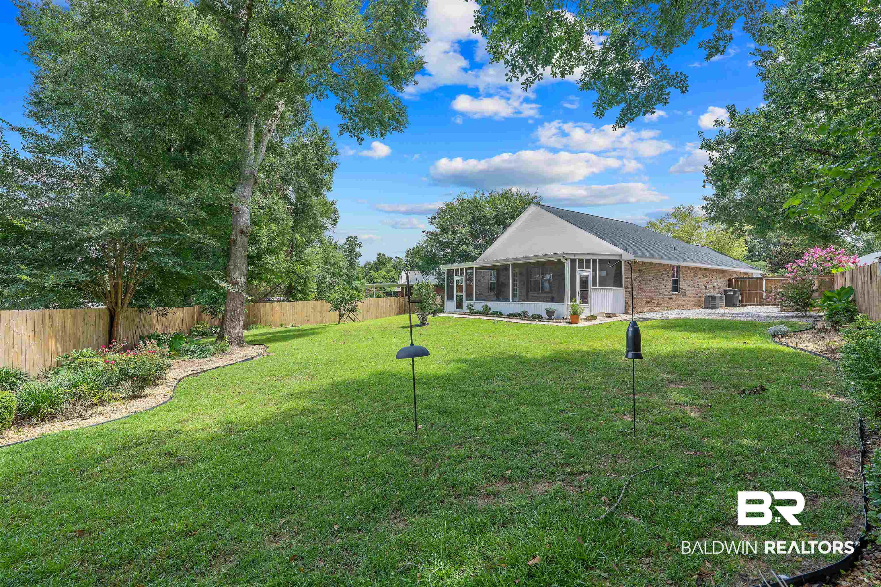 11097 Pontchartrain Loop Daphne, AL 36526 - Photo 7 of 28 Fenced backyard with a sunroom