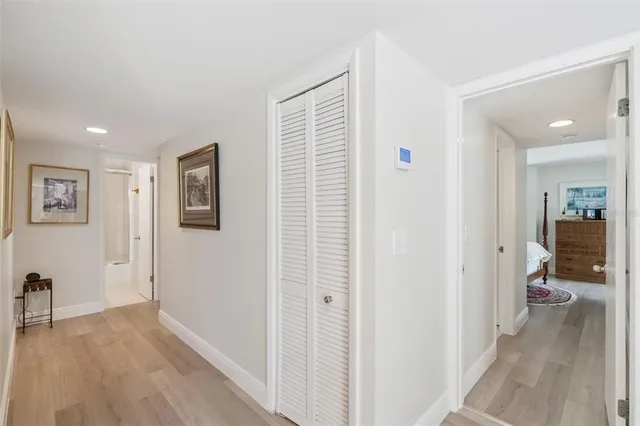 a view of a hallway with wooden floor and a living room