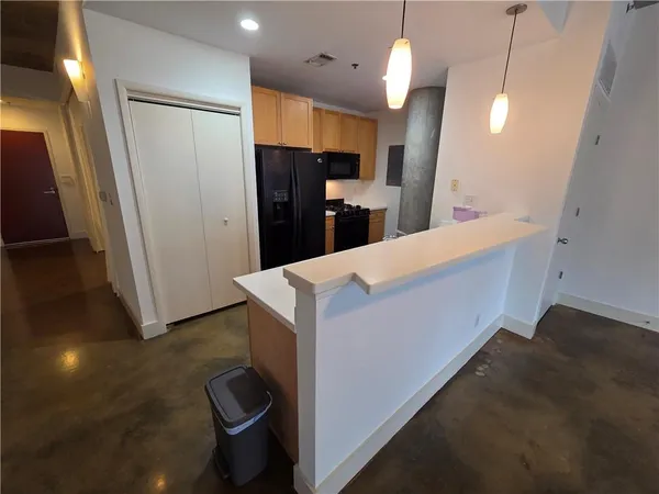 a kitchen with a refrigerator stove and microwave