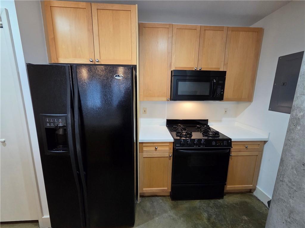 845 Spring Street Northwest, Unit 104 Atlanta, GA 30308 - Photo 14 of 40 a kitchen with a refrigerator stove and microwave