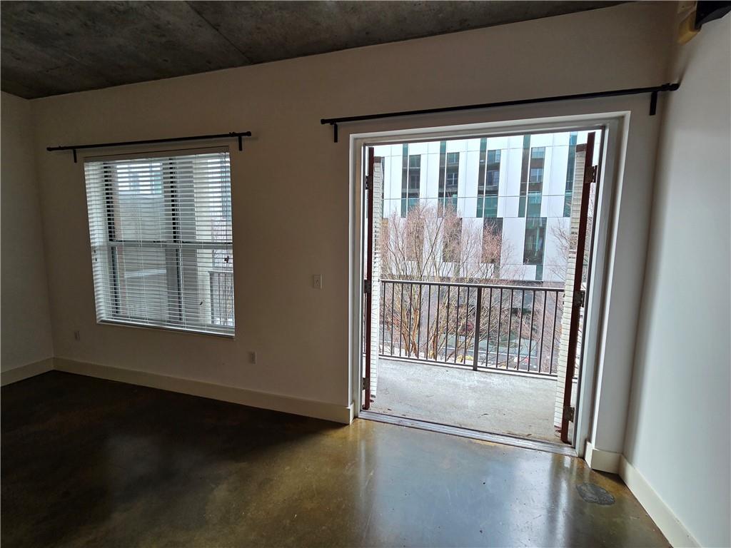 845 Spring Street Northwest, Unit 104 Atlanta, GA 30308 - Photo 19 of 40 a view of empty room with wooden floor and fan