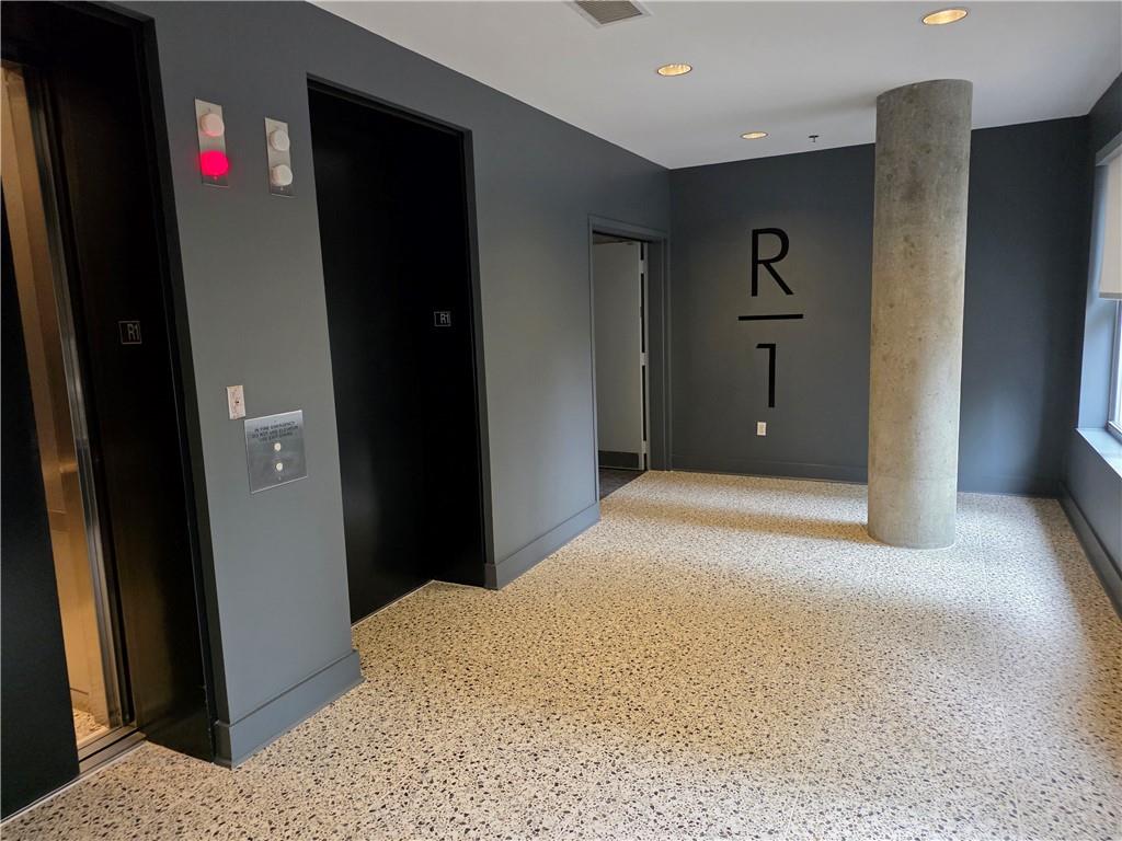 845 Spring Street Northwest, Unit 104 Atlanta, GA 30308 - Photo 22 of 40 a bedroom with a bed and a mirror