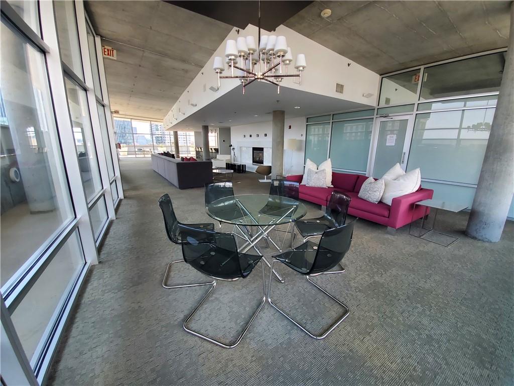 845 Spring Street Northwest, Unit 104 Atlanta, GA 30308 - Photo 26 of 40 a view of a dining room with furniture a chandelier and window