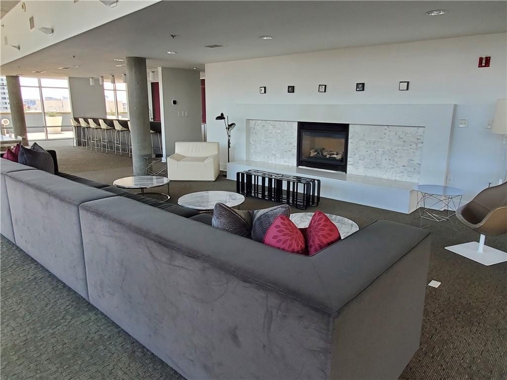 845 Spring Street Northwest, Unit 104 Atlanta, GA 30308 - Photo 27 of 40 a living room with furniture and a flat screen tv