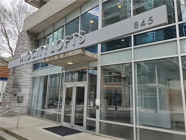 a front view of a building with glass windows and door