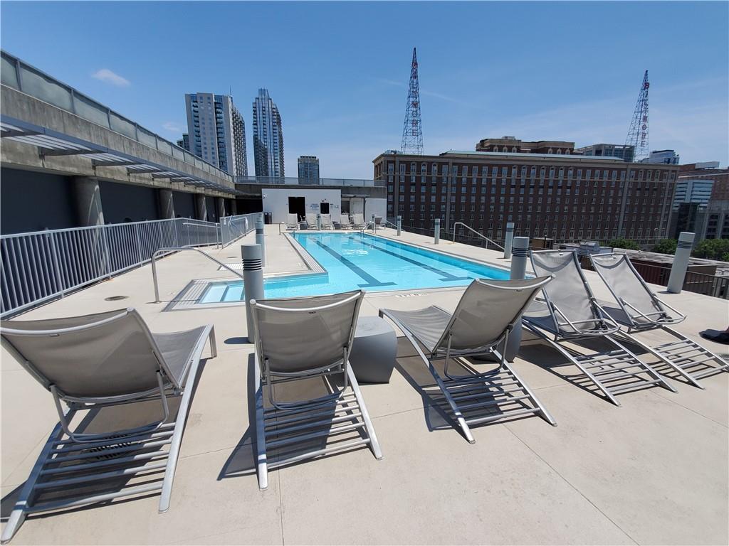 845 Spring Street Northwest, Unit 104 Atlanta, GA 30308 - Photo 32 of 40 a roof deck with table and chairs and wooden floor
