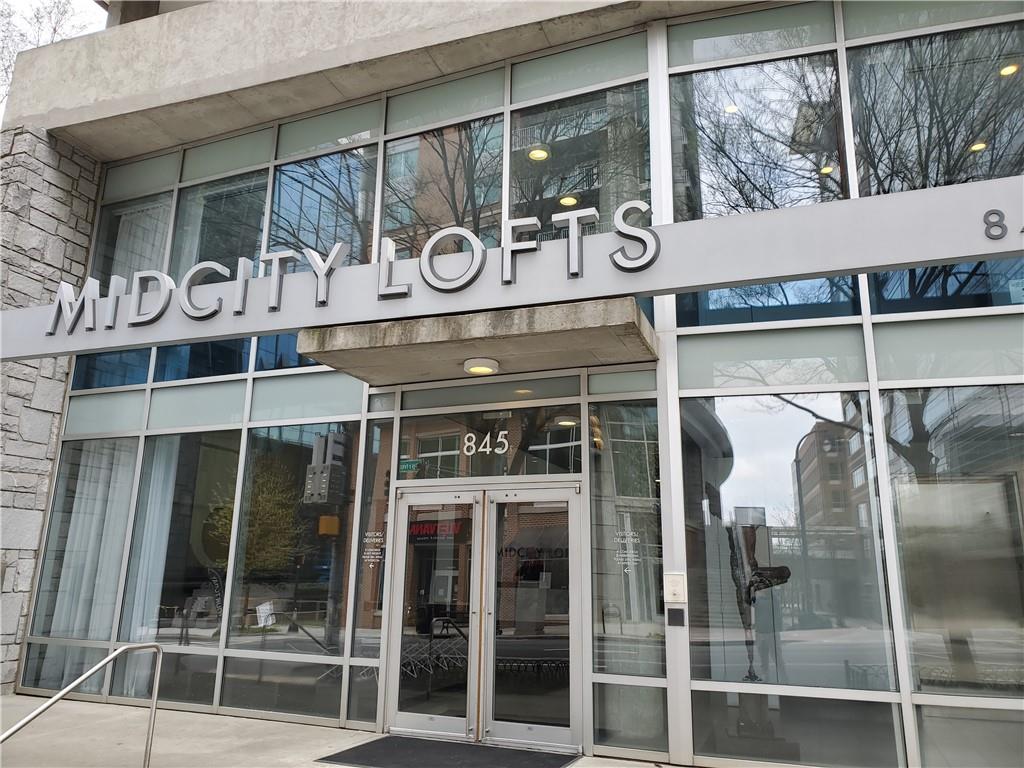 845 Spring Street Northwest, Unit 104 Atlanta, GA 30308 - Photo 40 of 40 a front view of a building with glass windows and door