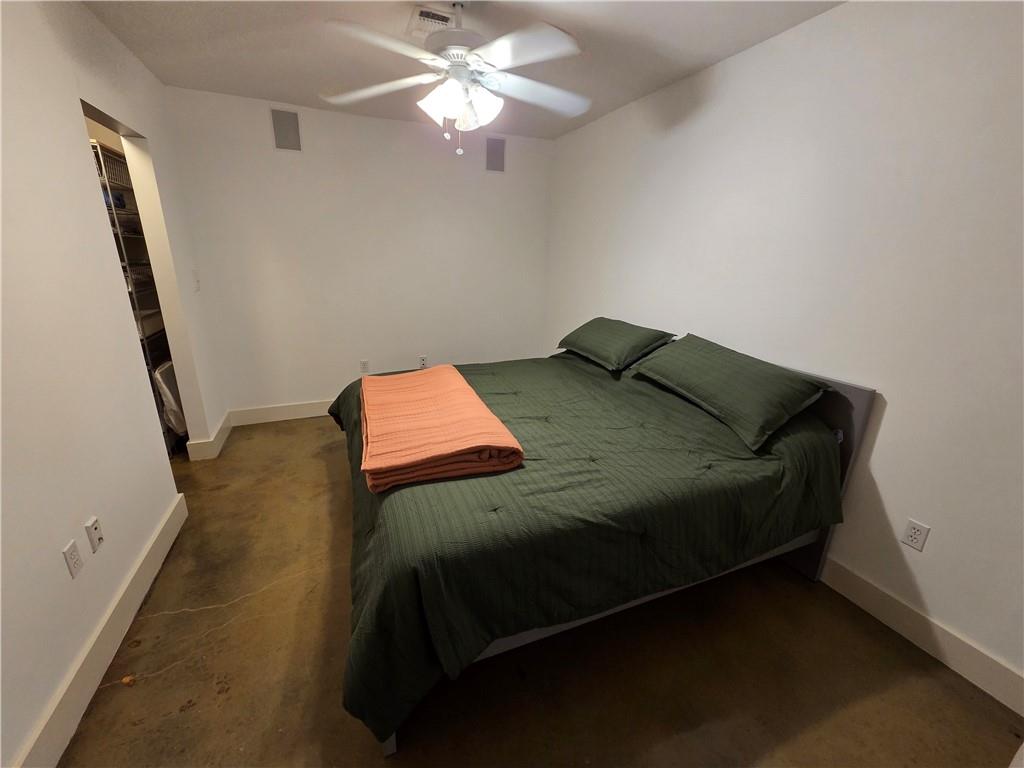 845 Spring Street Northwest, Unit 104 Atlanta, GA 30308 - Photo 5 of 40 a bedroom with a bed and a chandelier