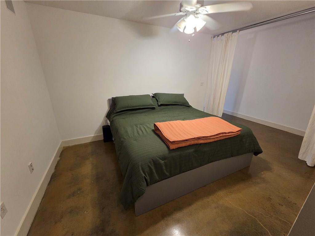 845 Spring Street Northwest, Unit 104 Atlanta, GA 30308 - Photo 6 of 40 a bedroom with a bed and a chandelier