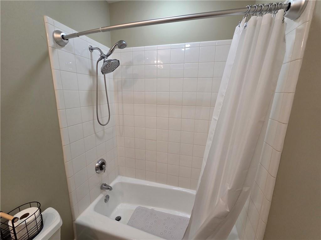 845 Spring Street Northwest, Unit 104 Atlanta, GA 30308 - Photo 8 of 40 a bathroom with a bath tub and a shower