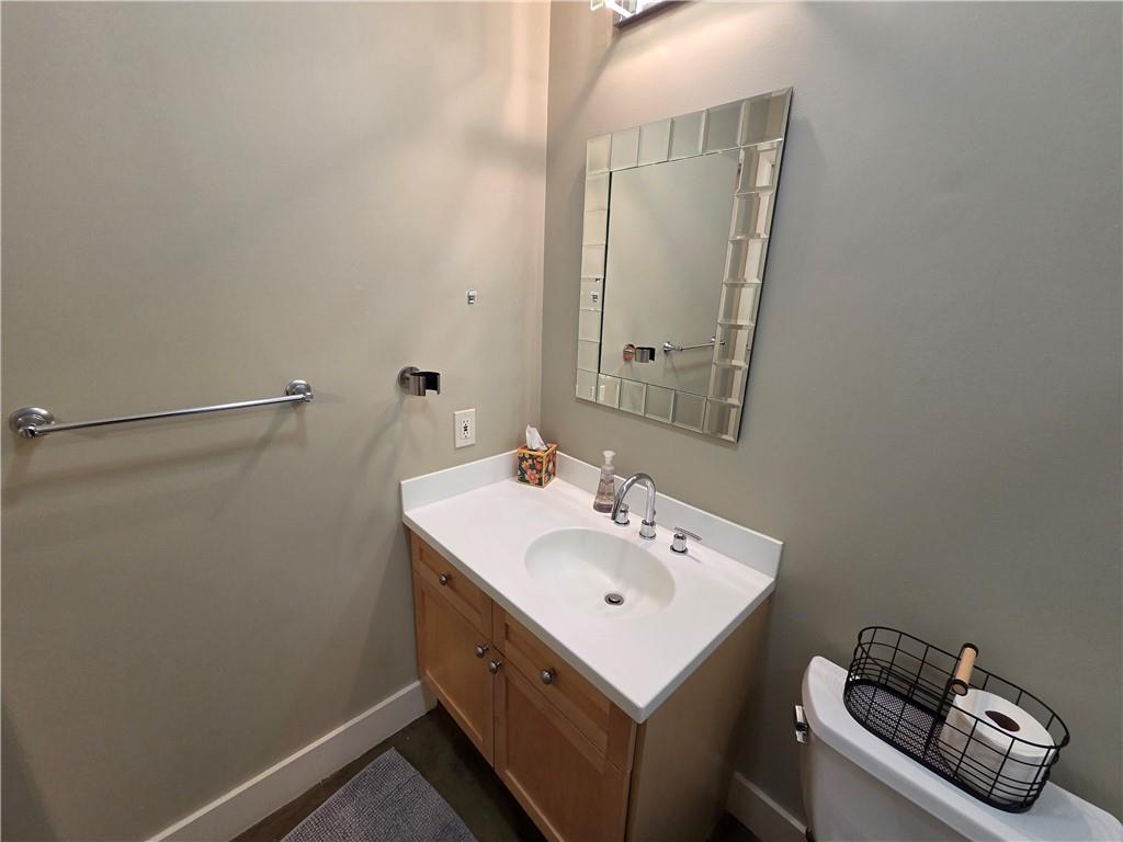 845 Spring Street Northwest, Unit 104 Atlanta, GA 30308 - Photo 9 of 40 a bathroom with a sink toilet and vanity