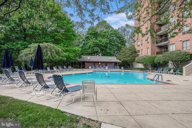 a view of backyard with swimming pool and table and chairs