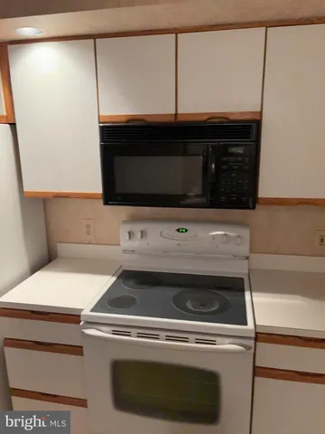 a kitchen with a stove and a microwave