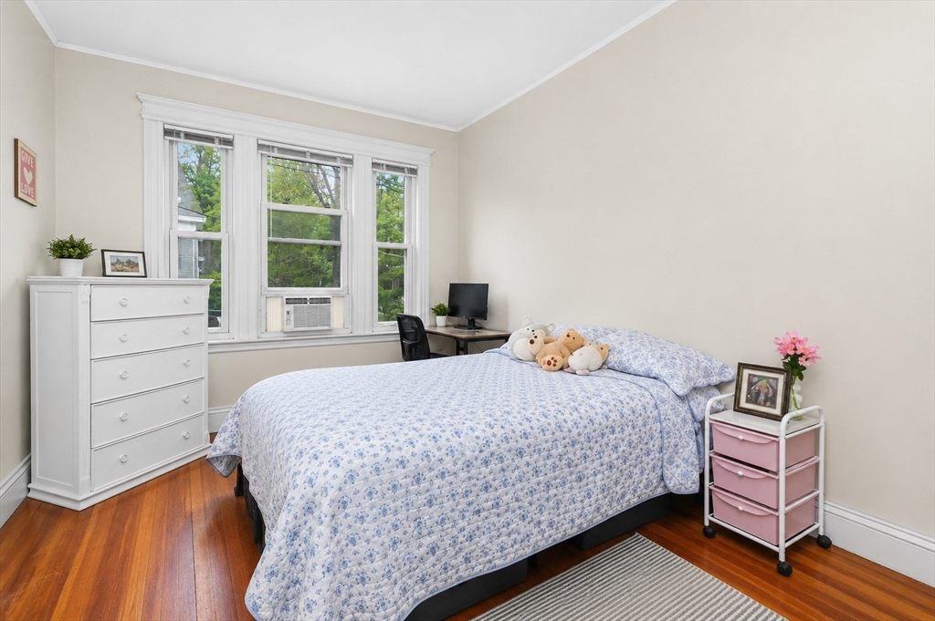 8 Colliston Road Boston, MA 02135 - Photo 8 of 40 a bedroom with a bed and wooden floor
