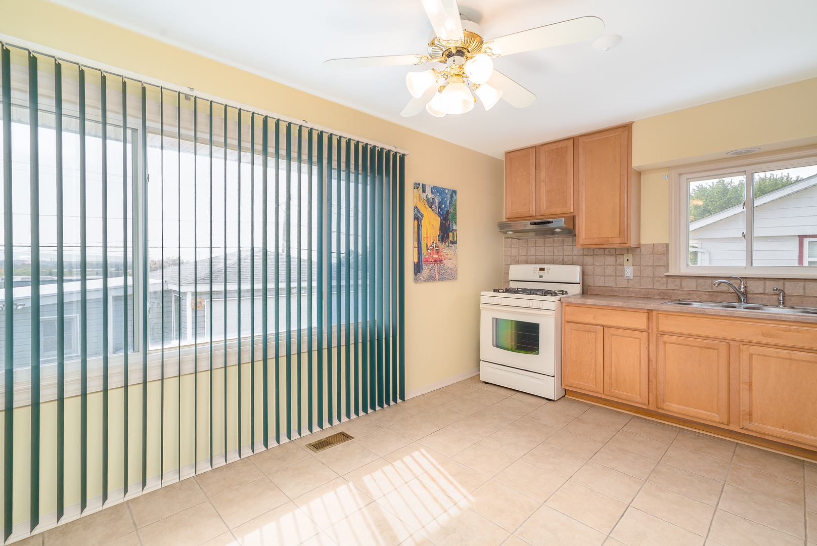 9 Ambassador Avenue Romeoville, IL 60446 - Photo 12 of 26 a kitchen with a white cabinets and window