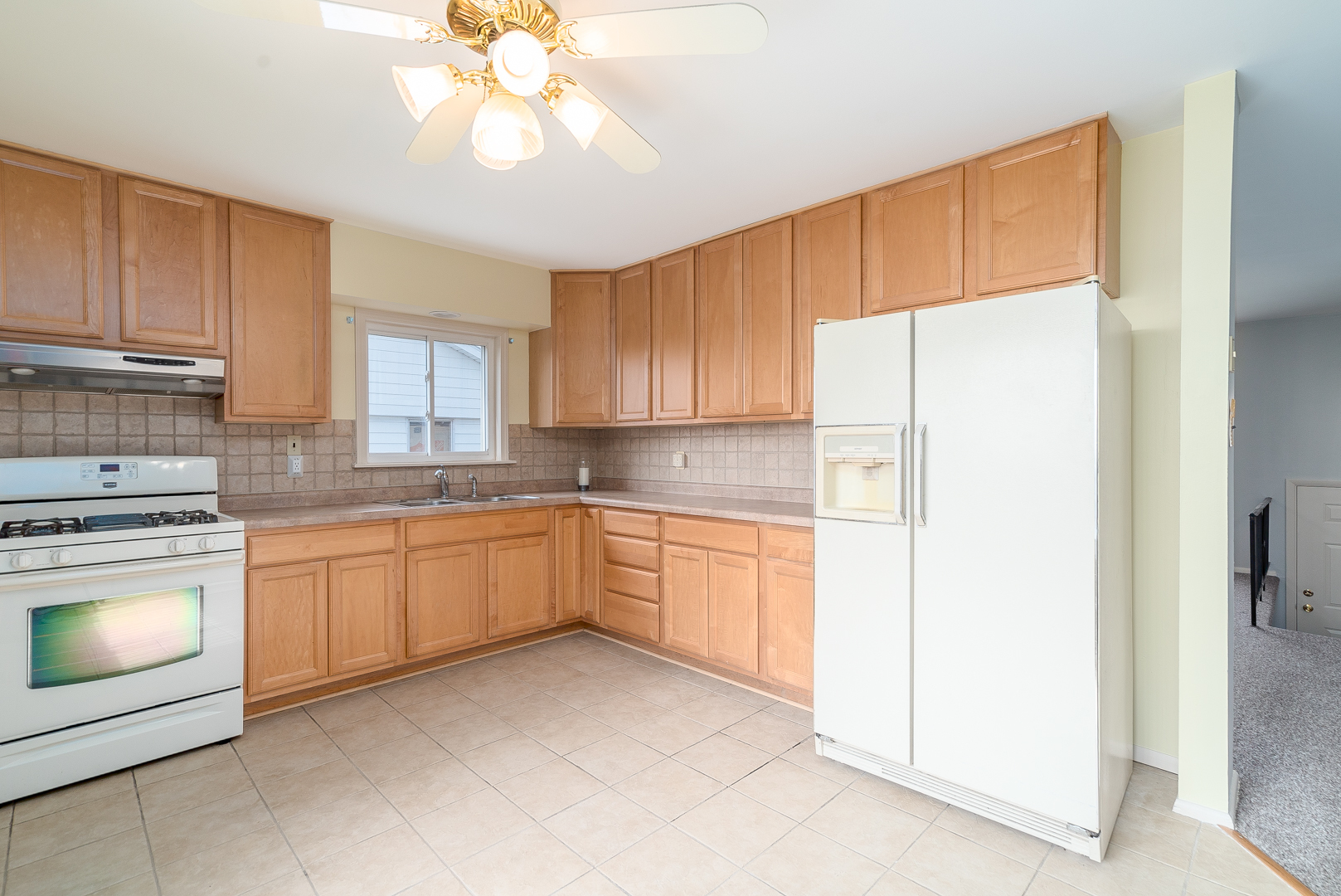 9 Ambassador Avenue Romeoville, IL 60446 - Photo 13 of 26 a kitchen with granite countertop white cabinets and white appliances