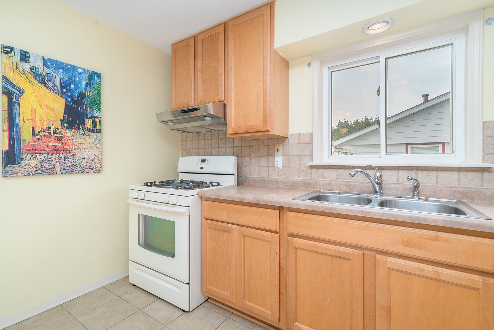 9 Ambassador Avenue Romeoville, IL 60446 - Photo 15 of 26 a kitchen with stainless steel appliances granite countertop a sink stove and white cabinets