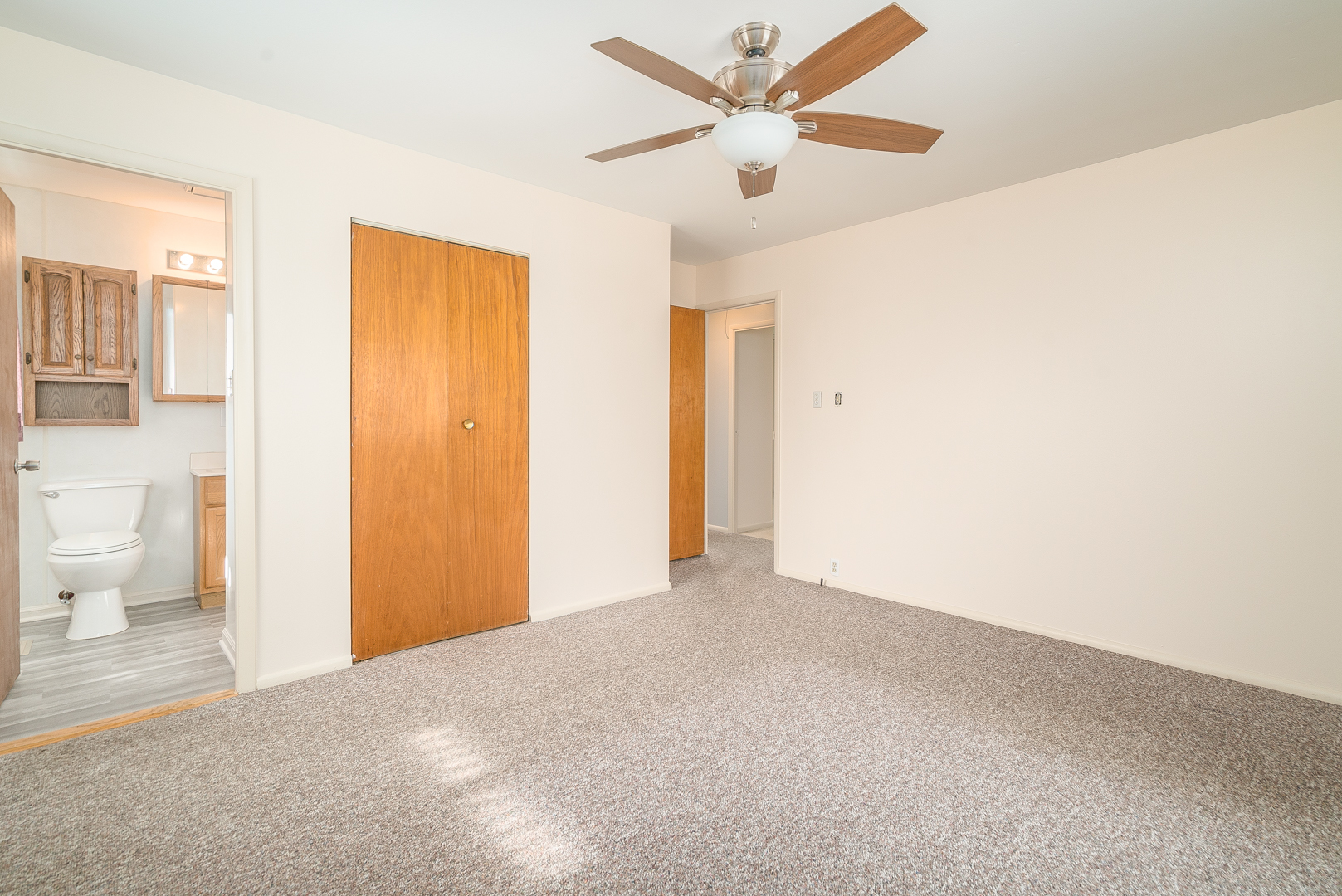 9 Ambassador Avenue Romeoville, IL 60446 - Photo 21 of 26 a view of a big room with wooden floor and a ceiling fan