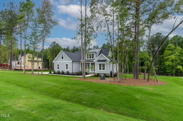 a kitchen with stainless steel appliances a sink a microwave a refrigerator and a stove