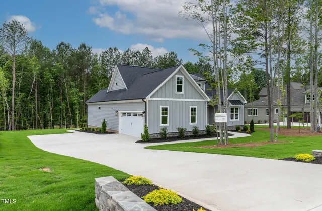 a view of a room with wooden floor chandeliers and kitchen view