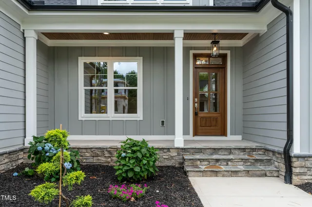 a kitchen with stainless steel appliances granite countertop a sink a stove and a wooden floors