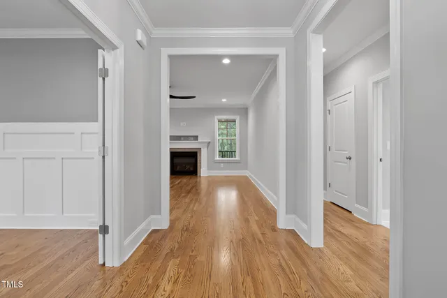 a kitchen with stainless steel appliances a sink a stove and a wooden floors