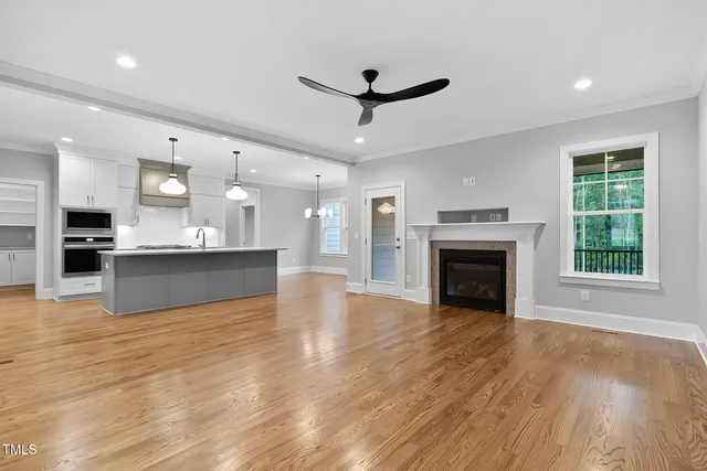 a view of a kitchen with white cabinets and a window