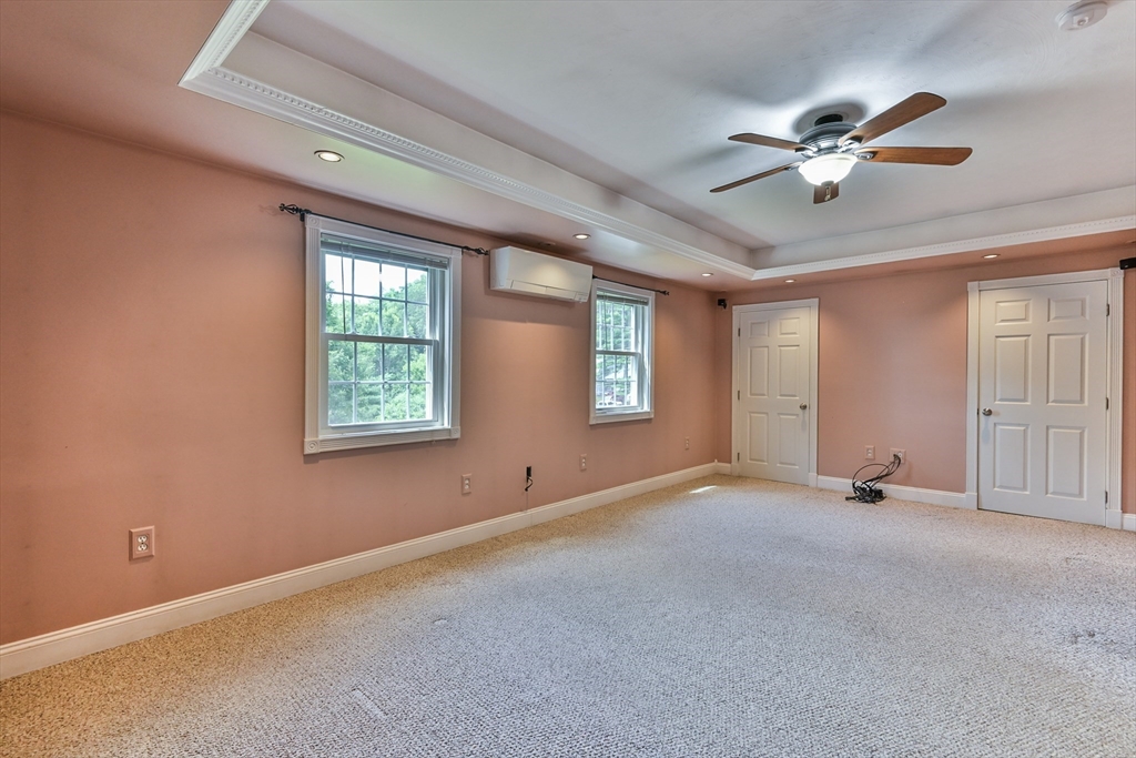 95 Charlton Road Dudley, MA 01571 - Photo 37 of 42 an empty room with windows and fan