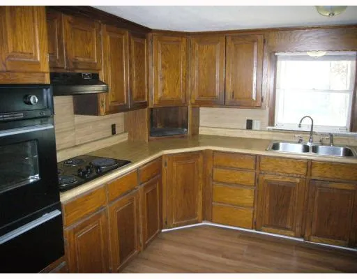 a kitchen with stainless steel appliances granite countertop wooden cabinets a stove a sink and dishwasher