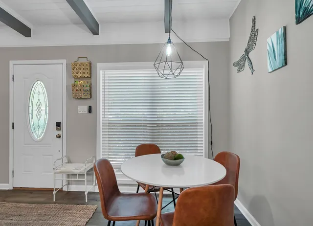 a dining room with furniture and window