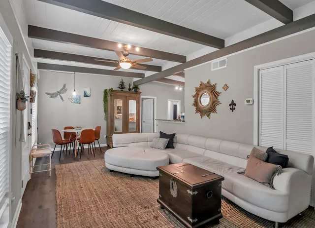 a living room with furniture and a chandelier