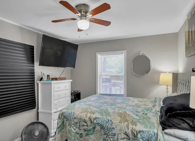 a bedroom with a bed and a flat screen tv