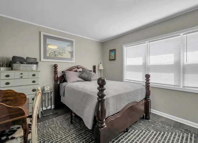 a bed sitting in a bedroom next to a window