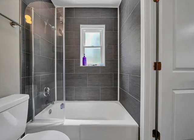 a bathroom with a bathtub and a shower