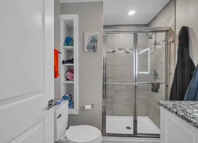 a bathroom with a shower toilet and sink