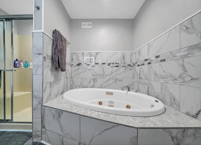 a bathroom with a bathtub and a shower
