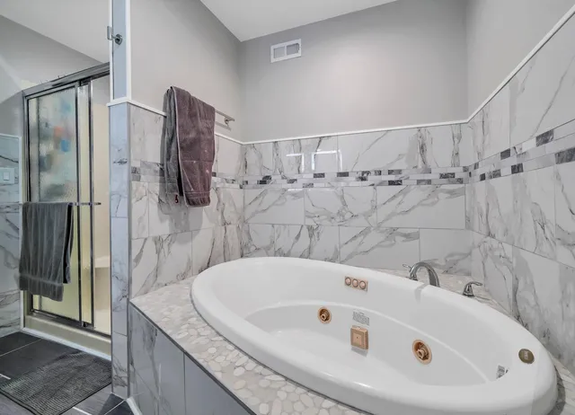 a bathroom with a bathtub and shower